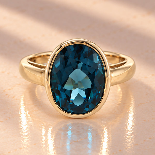 9ct Yellow Gold Oval Rubover Set London Blue Topaz