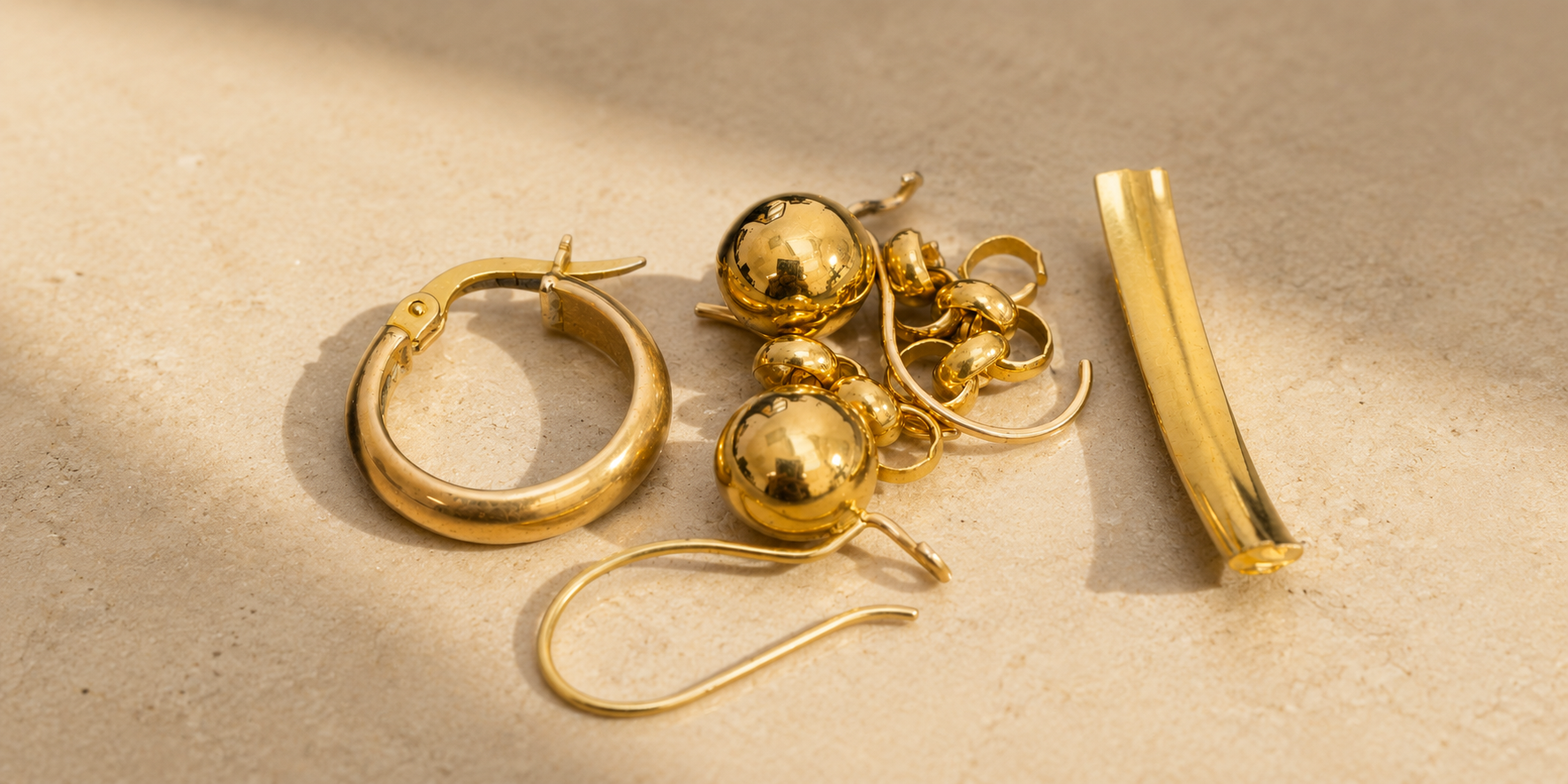 Old yellow gold earrings and jewellery ready to be reused in a jewellery remodelling project at Fishers Jewellers.
