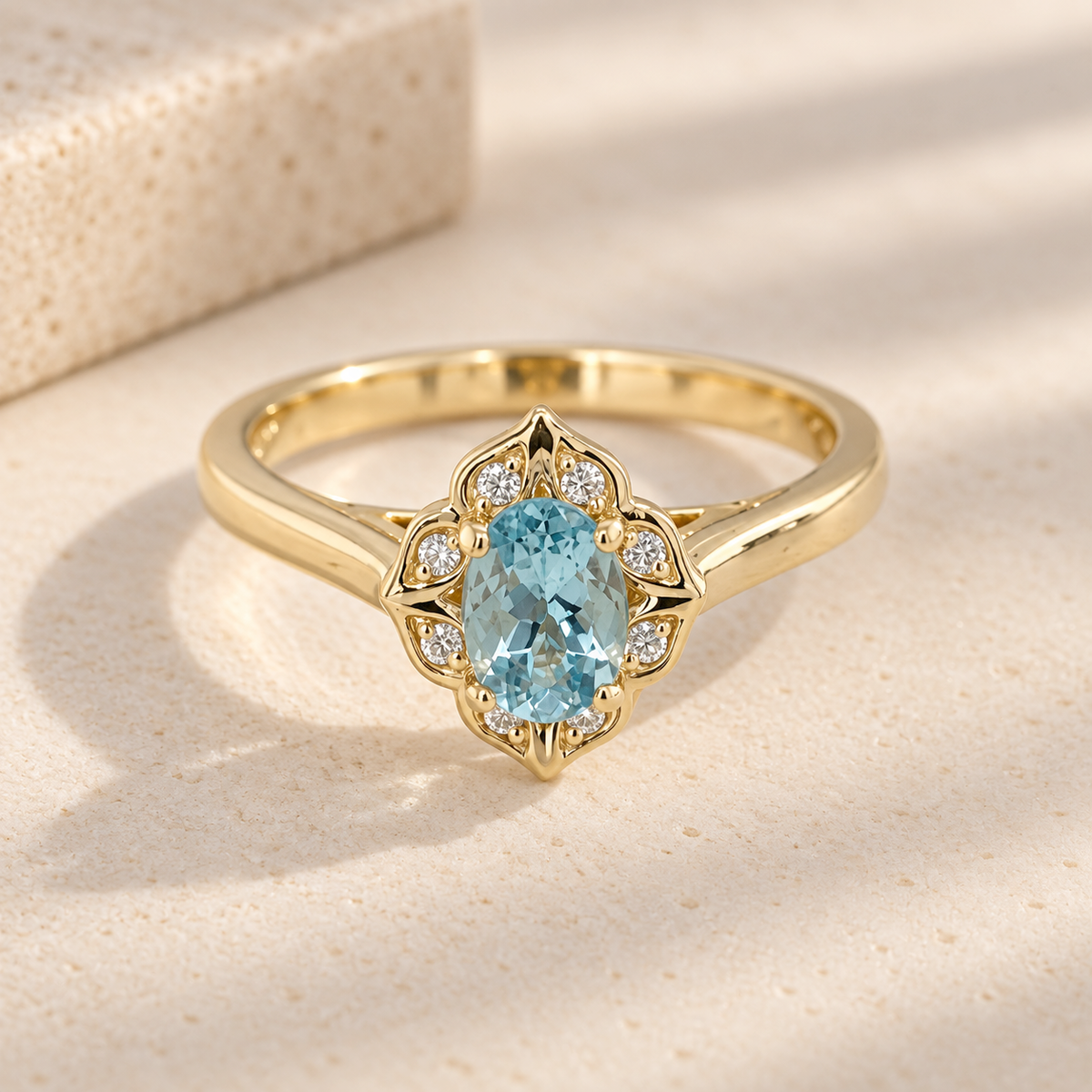 14ct yellow gold aquamarine and diamond halo ring with oval aquamarine centre stone