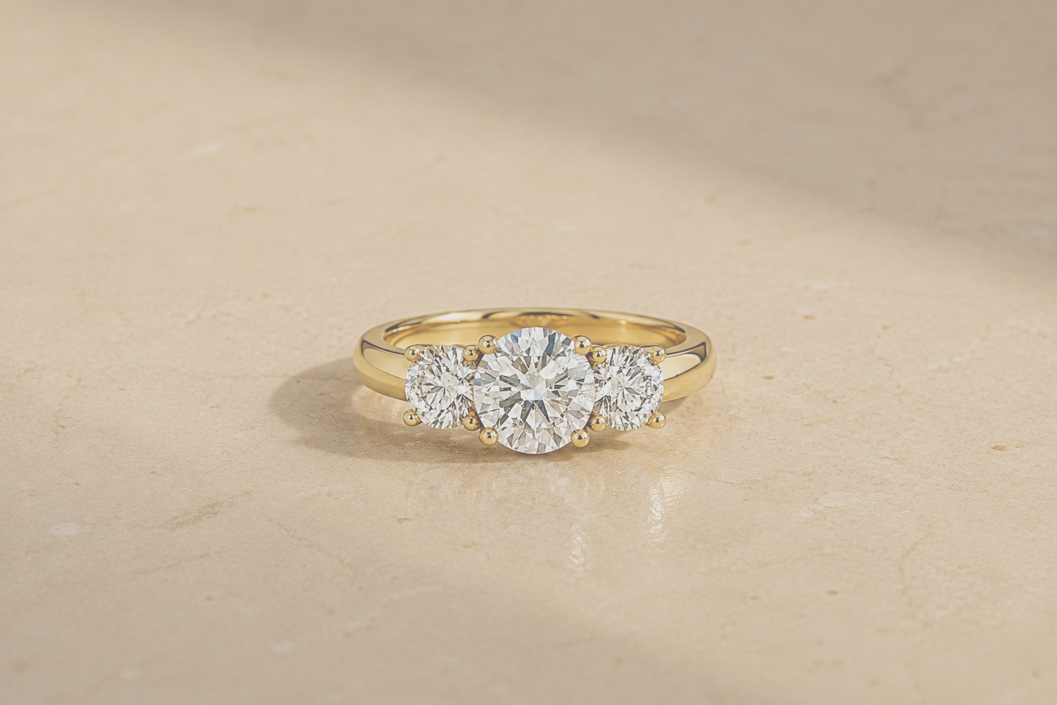 Three-stone diamond engagement ring in yellow gold with round brilliant-cut diamonds