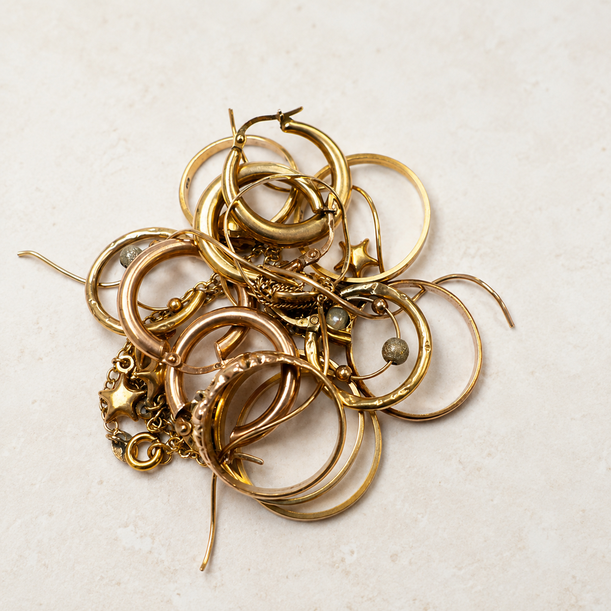Collection of unworn yellow gold jewellery ready to be reused in a jewellery remodelling project at Fishers Jewellers.